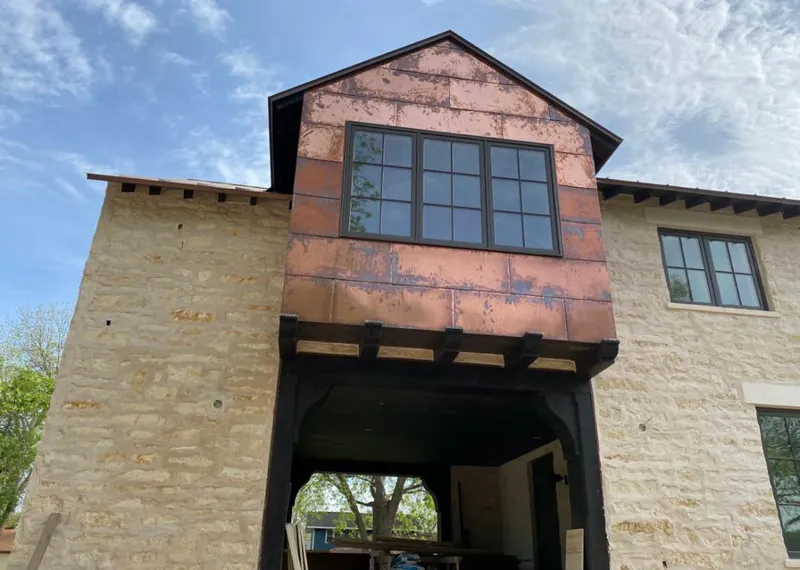Copper metal panel facade on a stone building for Skylight Installation in Okmulgee