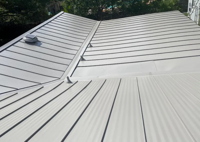 Solar attic fan installed on a metal roof for Roof Ventilation in Okmulgee